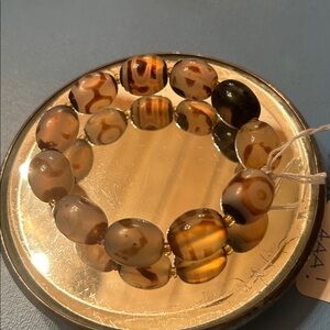 SUPER SARDONYX AGATE Bracelet with tiny beads separating each larger bead.